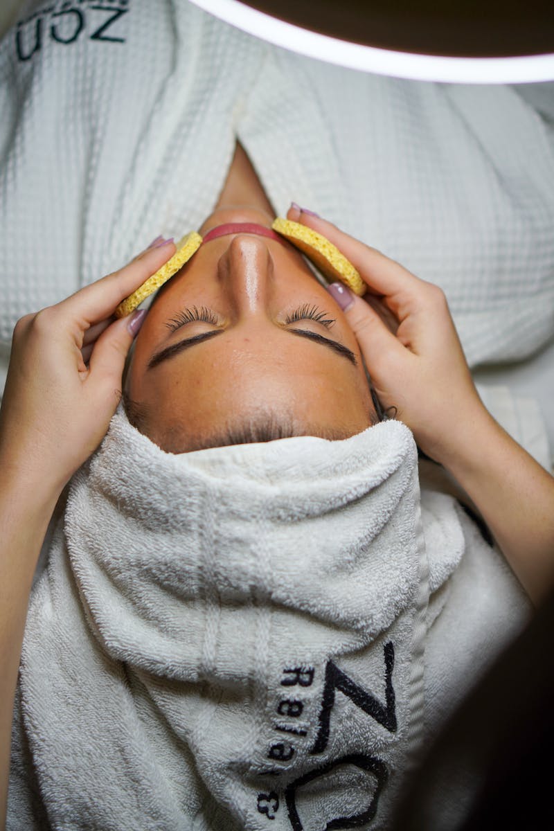 Home Relaxing spa treatment with facial and sponge massage in a serene environment.